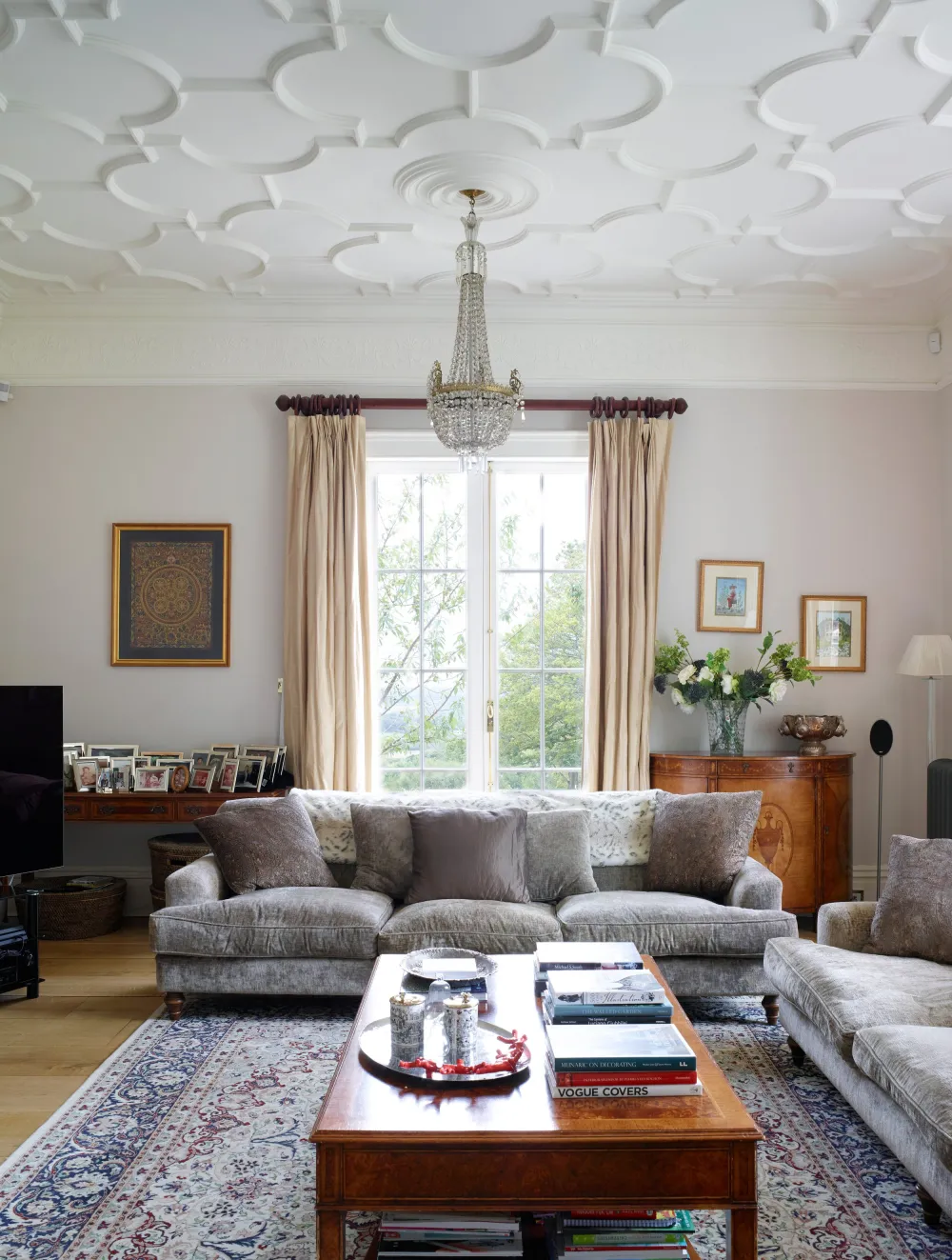 Sitting room with sofas, coffee table and full length curtains