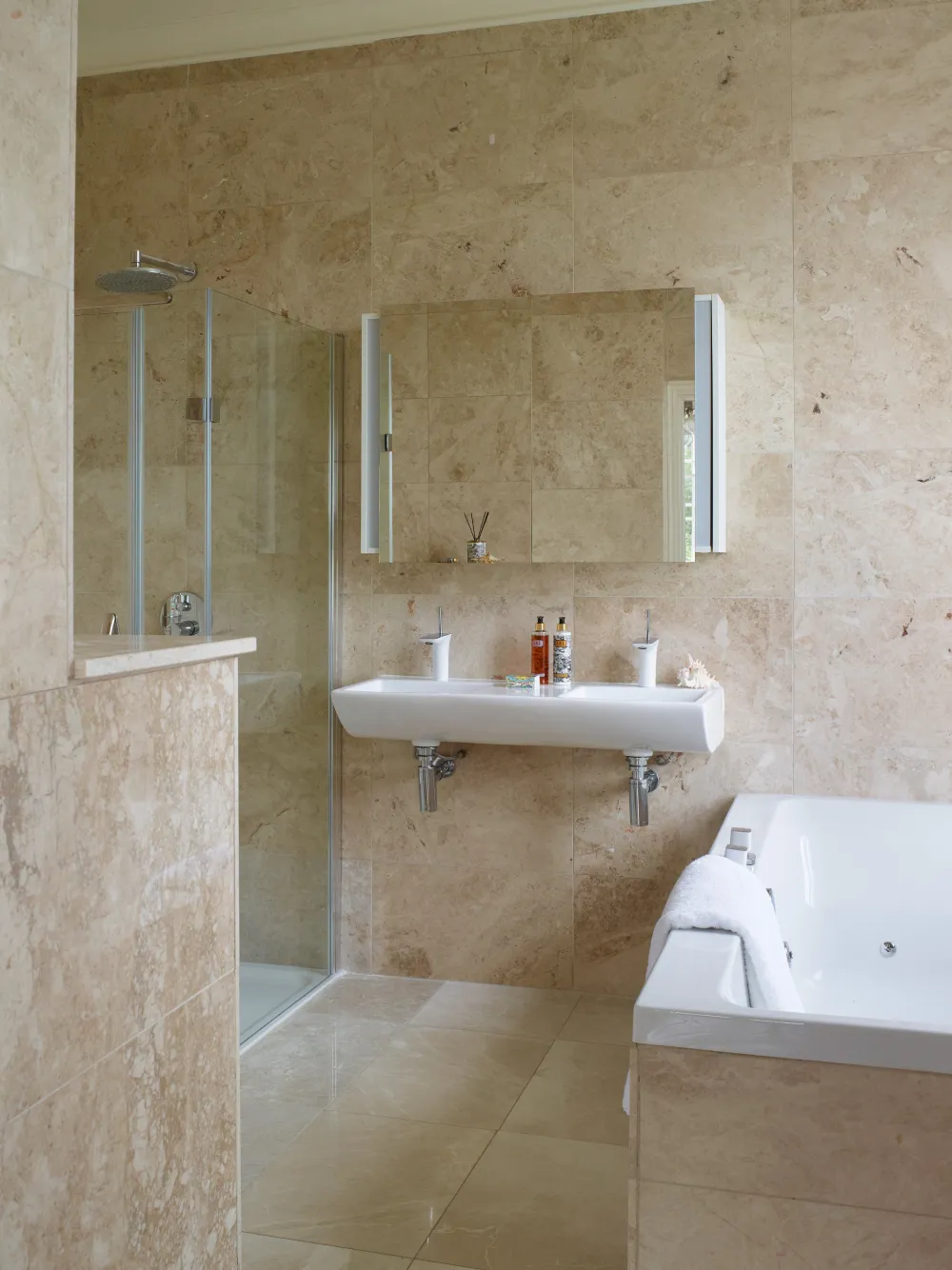 Natural stone bathroom with double sink and double bath